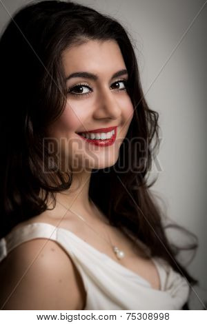 Portrait Of A Beautiful Smiling Young Brunette Woman