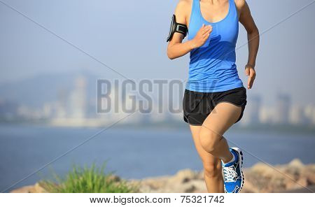 Runner athlete running at seaside city