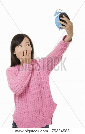 Beautiful Chinese Woman Holding A Blue Alarm Clock