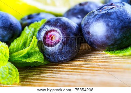 Fresh blueberries green leaves, citrus fruit - lemon limet