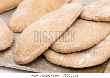 Loaves of traditional Egyptian homemade brown pita bread, fresh from the oven. called aish baladi