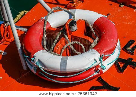 Close-up Of A Red And White Weatherd Life-belt (buoyancy Aid) On The Deck Of A Fishing Boat.