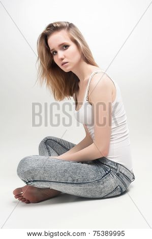 Attractive sad woman on floor