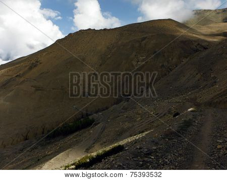 Trekker's Trail And Suspension Bridge In Dry Himalayan Landscape