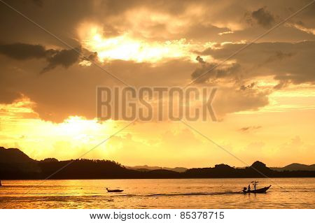 Traditional Fisherman Long Tailed Boat In Koh Phitak Island, Thailand At Sunset.