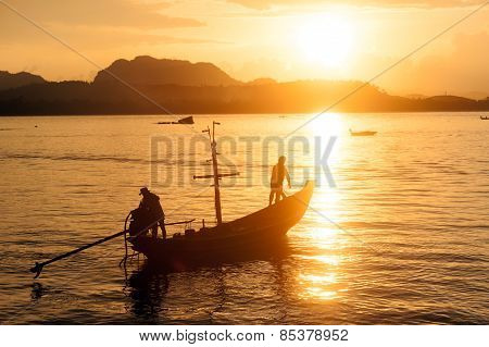 Traditional Fisherman Long Tailed Boat In Koh Phitak Island, Thailand At Sunset.