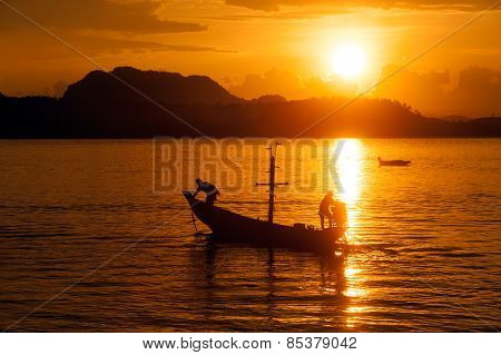 Traditional Fisherman Long Tailed Boat In Koh Phitak Island, Thailand At Sunset.