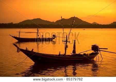 Traditional Fishing Long Tailed Boat In Koh Phitak Island, Thailand At Sunset.