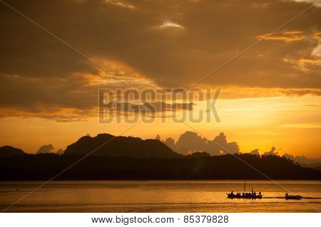 Traditional Fisherman Long Tailed Boat In Koh Phitak Island, Thailand At Sunset.