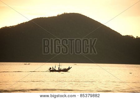 Traditional Fisherman Long Tailed Boat In Koh Phitak Island, Thailand At Sunset.