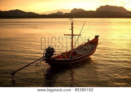 Traditional Fisherman Long Tailed Boat In Koh Phitak Island, Thailand At Sunset.