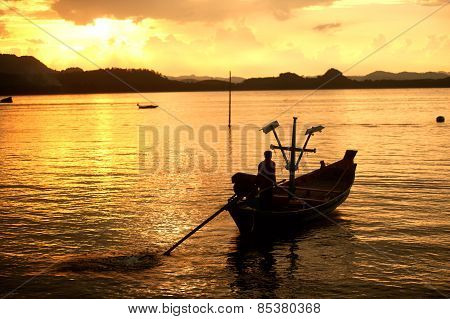 Traditional Fisherman Long Tailed Boat In Koh Phitak Island, Thailand At Sunset.