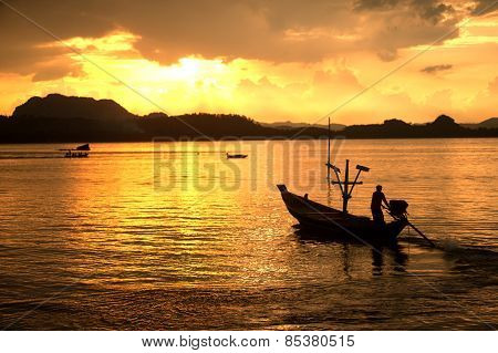 Traditional Fisherman Long Tailed Boat In Koh Phitak Island, Thailand At Sunset.