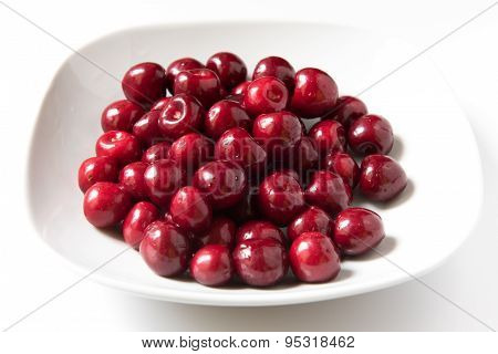Bowl Of Red Fresh Cerries On A White Background