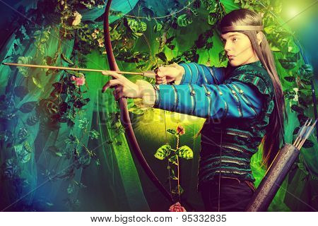 Portrait of a male elf with a bow and arrows in a magical forest.