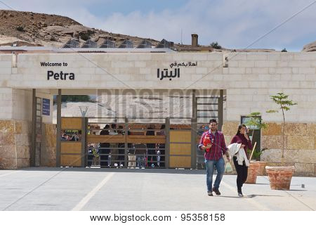 PETRA, JORDAN - MARCH 15, 2014: Tourists near the main entrance to Petra. Since 1985, Petra is listed as UNESCO World Heritage site