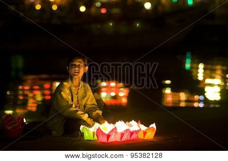 Little girl sell flower garlands in Hoian ancient town