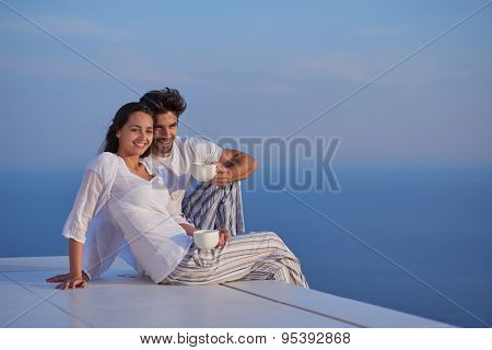 happy young romantic couple have fun relax smile at modern home outdoor terace balcony terace