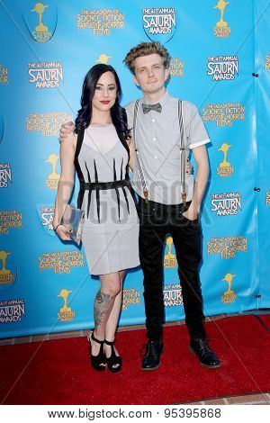 BURBANK - JUNE 25: Erik Knudsen and guest arrive at the 41st Annual Saturn Awards on Thursday, June 25, 2015 at the Castaway Restaurant in Burbank, CA.
