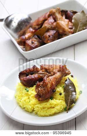 chicken and pork adobo over yellow rice, filipino food