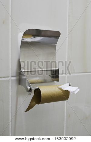 metal toilet paper holder with a spent roll