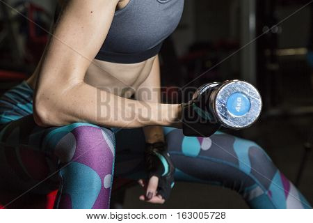 Young Woman Goes In For Sports At Gym