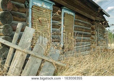 Wooden abandoned old house with the driven-in windows in Preobrazhenskoe. Tyumen region. Russia