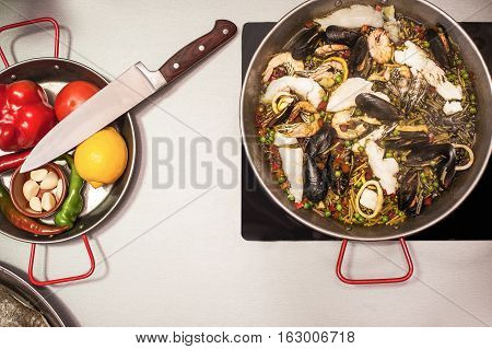 Italian pasta fideua with seafood, oysters, black pasta