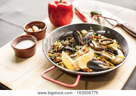 Italian pasta fideua with seafood, oysters, black pasta