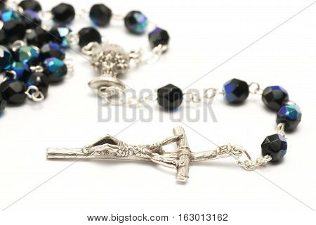 Rosary, silver cross on a white background