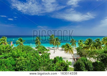 stunning gorgeous beautiful, amazing view of Holguin province tropical inviting beach and tranquil azure turquoise ocean on blue sky background