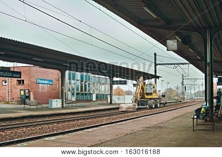 Chomutov Ustecky kraj Czech republic - November 20 2016: detail of train station named Chomutov mesto with excavator parked on the rail before the start of the reconstruction of peron and track