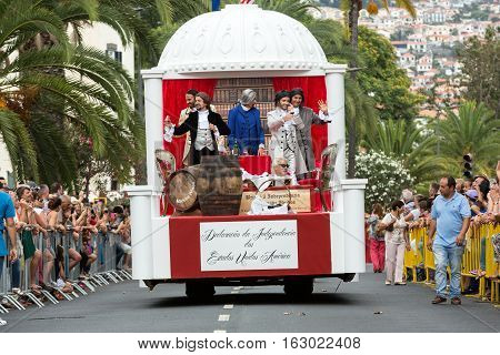FUNCHAL MADEIRA PORTUGAL - SEPTEMBER 4 2016: Men in historical fashion dress raise toasts durnig historical and ethnographic parade of Madeira Wine Festival in Funchal. Madeira Portugal