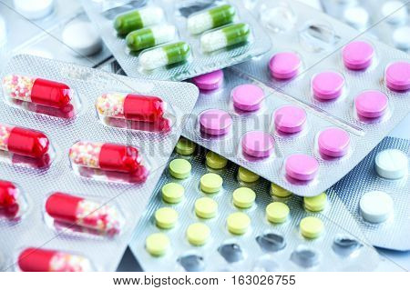 Overall view of pharmaceutical tablets and capsules in packages in assortment
