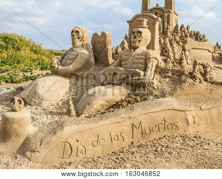 A sandcastle featuring the "day of the dead". Gone now to the waves.
