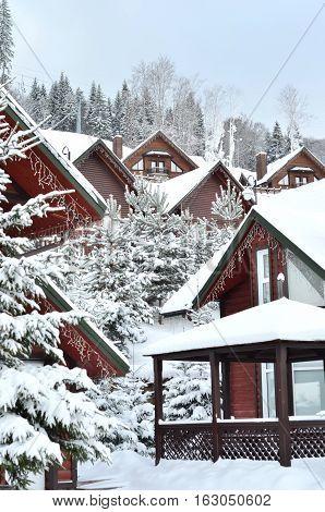 Snow covered chalet in the mountains . Traditional alpine cabin