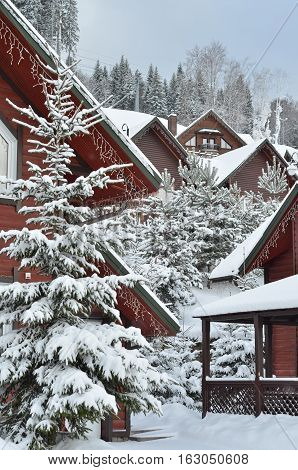 view of scenic white winter  scenery in the Alps with traditional mountain chalet