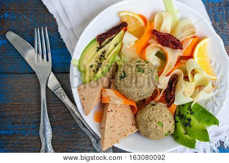 Zucchini pasta with tofu lentil balls avocado carrots. Vegan healthy lunch or dinner. Love for a healthy raw food