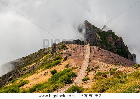 Hiker admiring Pico do Arierio, Pico Ruivo, Madeira, Portugal Europe