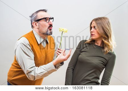 Nerdy man wants to marry to a beautiful woman but she is terrified, she doesn't want to marry.