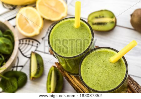 Fresh and healthy green smoothie with spinach,banana and kiwi. Vegetarian breakfasts. Picture with space for text or logos.