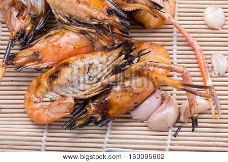Burn Shrim And Seafood Sauce On Wooden Table.