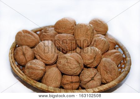 Macro Photo Of Nuts In Straw Plate.