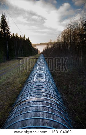 Tube of water down to a turbine near lake