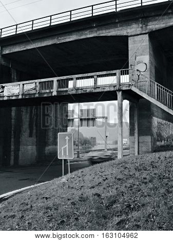 Usti nad Labem Ustecky kraj Czech republic - November 20 2016: afternoon black and white photo of large railway bridge and small pedestrian bridge over the Elbe river