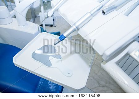 Dentist Mirrow On The Working Surface With Other Equipment On The Background In Dental Office. Selec