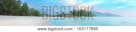 Sea of mist and sunrise at white sand beach of Koh Chang. Beautiful tropical Thailand island panoramic for holiday vacation background concept.