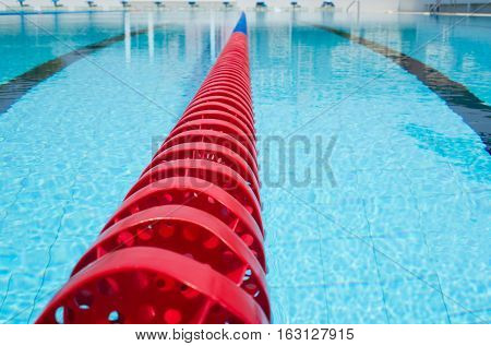 plastic swimming pool lane rope floating on water surface