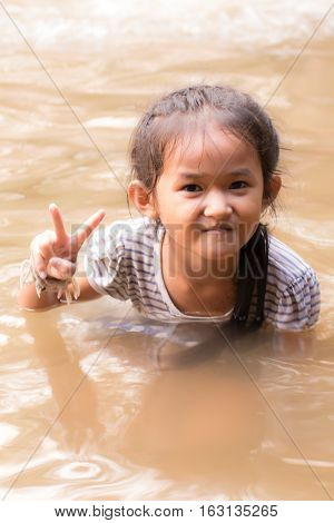 asia girl in river , Thai children