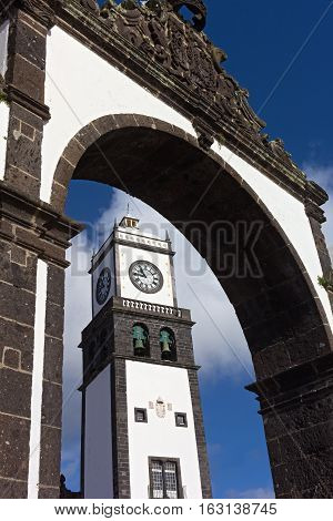 St. Sebastian Church Tower framed in Ponta Delgada town gate. The church located on the Main Square of Ponta Delgada Azores Portugal.